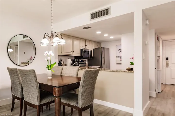 Dining space featuring light wood-style floors, baseboards, visible vents, and recessed lighting