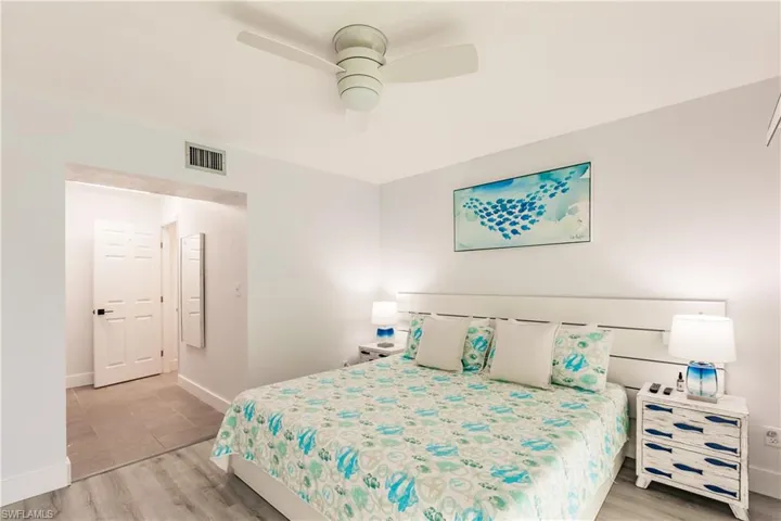 Bedroom with a ceiling fan, baseboards, visible vents, and light wood finished floors