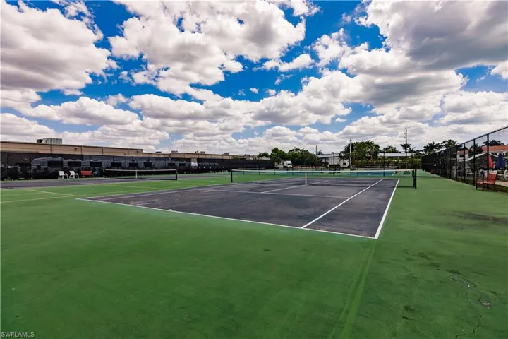 View of tennis court featuring fence