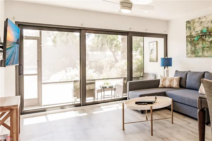 Living area with light wood-type flooring and a ceiling fan