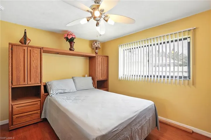 Bedroom with dark wood finished floors and ceiling fan