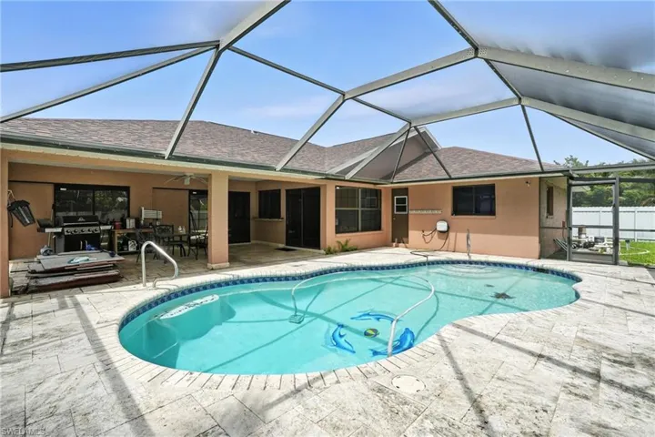 Swimming pool featuring a patio, a ceiling fan, a lanai, and a grill