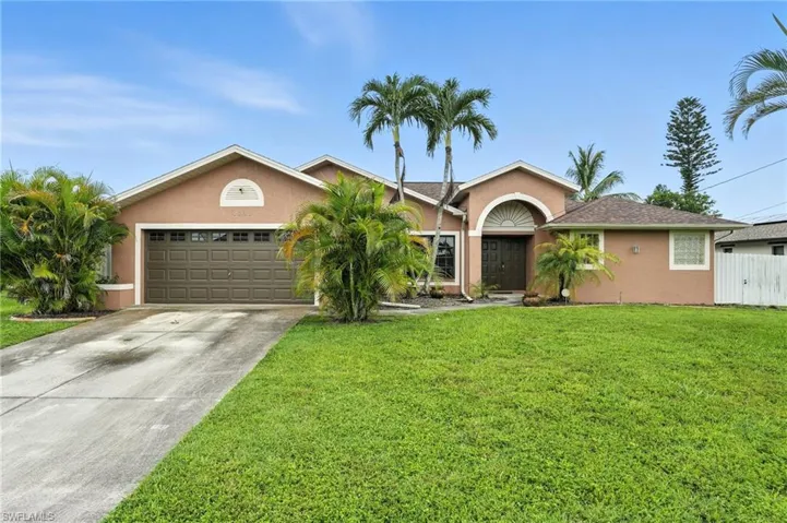 Single story home with stucco siding, concrete driveway, and an attached garage