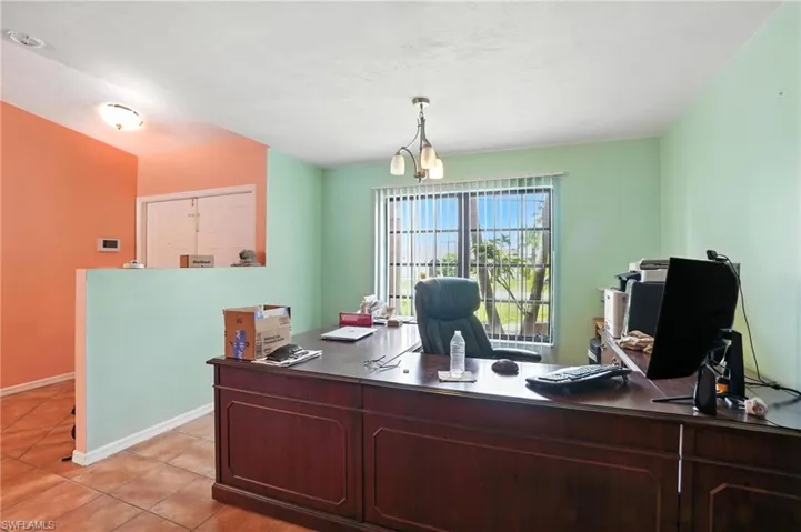 Office featuring light tile patterned flooring and baseboards