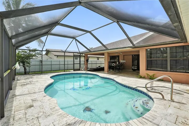 View of swimming pool featuring a patio area, a fenced backyard, and a lanai
