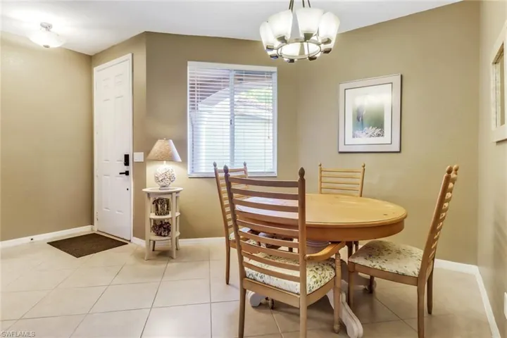 Dining area featuring light tile floors and an inviting chandelier
