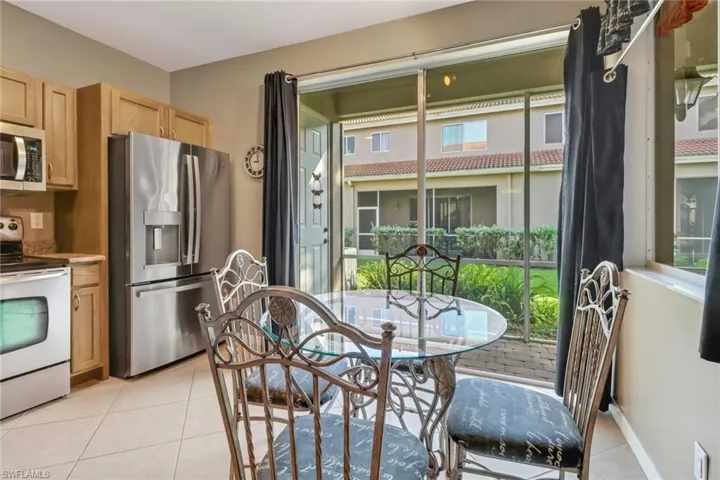Kitchen with appliances with stainless steel finishes and light tile floors