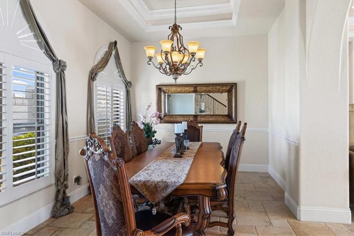 Large formal dining area. Downstairs living areas open to pool and waterfront.