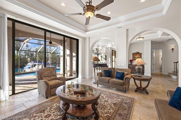 Downstairs living areas open to pool and waterfront.