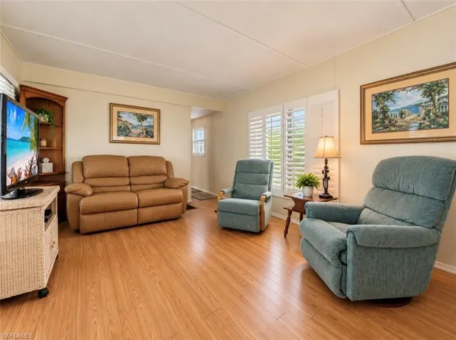Wood-finish flooring, plantation shutters, and built-in corner shelving