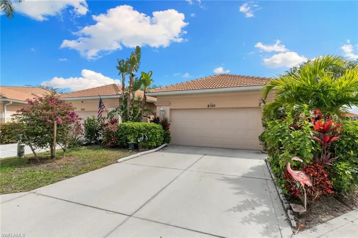 View of front of home with a garage, concrete driveway, a tile roof, and stucco siding