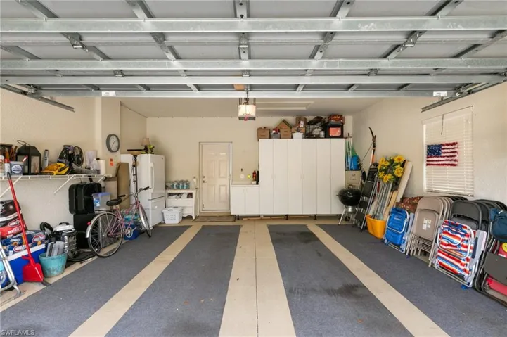Garage featuring freestanding refrigerator