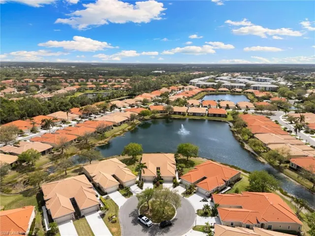 Aerial view of residential area featuring a nearby body of water