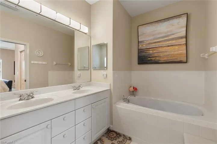 Ensuite bathroom with double vanity and a bath