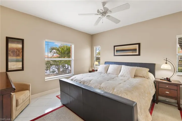 Bedroom featuring a ceiling fan and baseboards