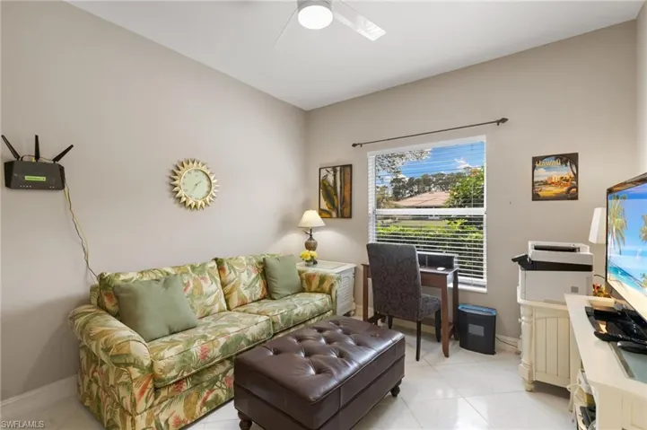 Living area featuring baseboards and a ceiling fan
