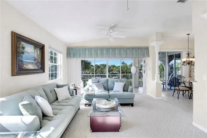 (Virtual wall color change) Spacious living room with lots of natural light, carpeted flooring and beautiful view from the 2nd story overlooking the lake.