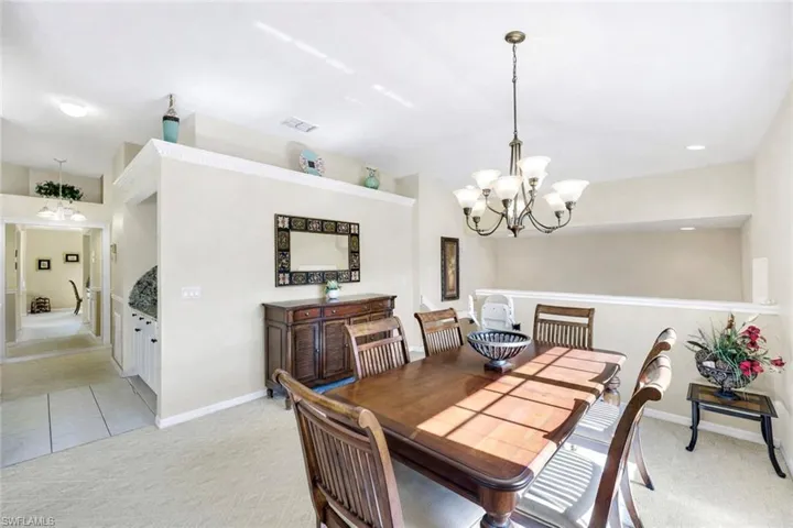 (Virtual wall color change) Formal dining area with large dining table perfect for gathering with family and friends.