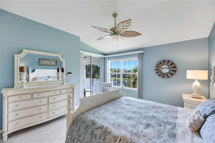Primary bedroom with lots of natural light, carpeted flooring and beautiful views of the fountains and lake with private entrance to the patio.