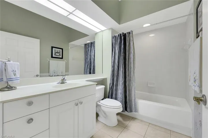 Guest bathroom with bathtub and shower.