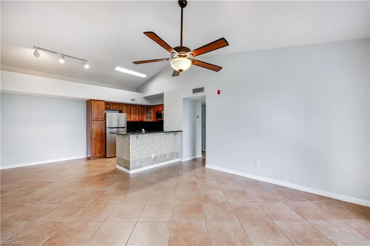 Kitchen featuring ceiling fan, light tile patterned flooring, appliances with stainless steel finishes, and kitchen peninsula