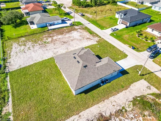 Newly constructed single-story residence featuring a gray shingle roof and white exterior