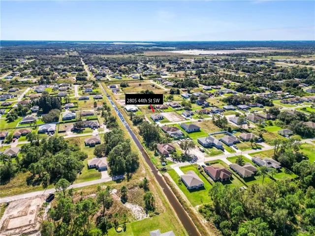 Aerial perspective showcasing a residential neighborhood with single-story homes and mature trees