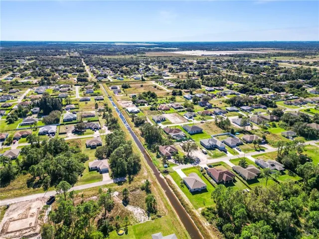 Expansive aerial view showcasing a residential area with a clear blue sky