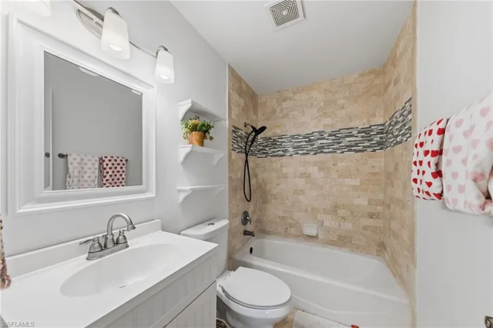 Bathroom with vanity and shower / bath combination