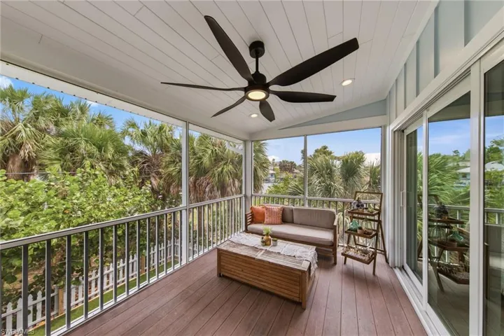 Screened Porch featuring outdoor seating, a ceiling fan, and a deck
