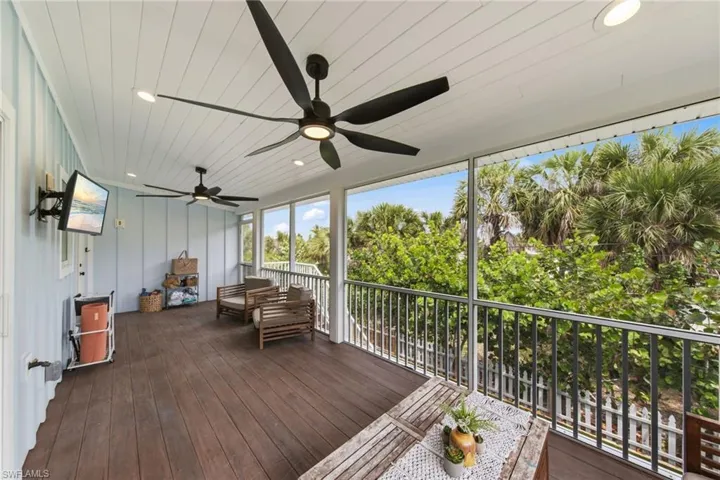 Screened Porch featuring outdoor seating, a ceiling fan, and a deck