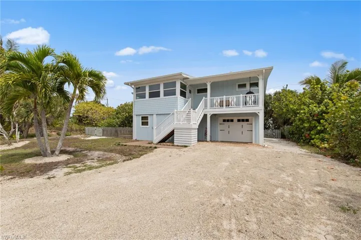Coastal home with driveway and a garage