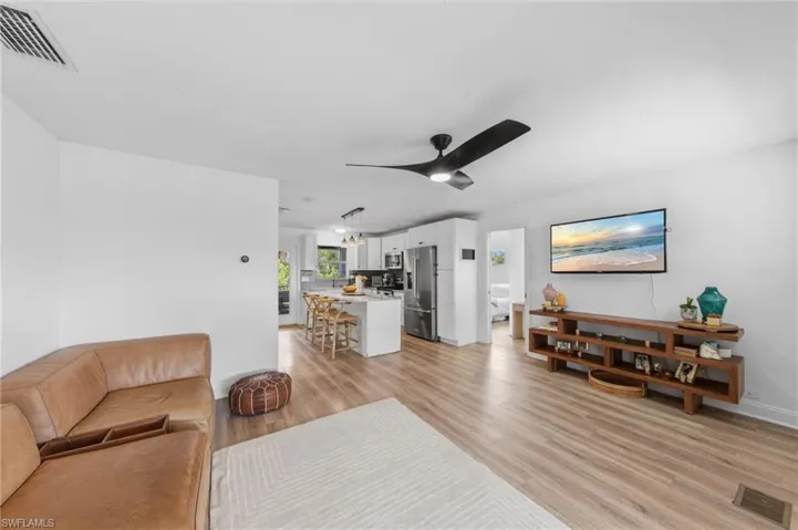 Living room featuring light wood-style floors and a ceiling fan