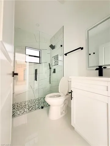Bathroom featuring vanity and a shower stall