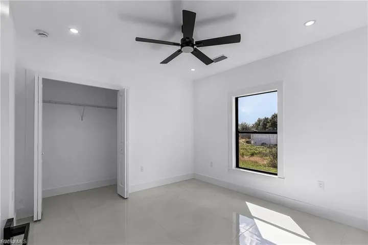 Unfurnished bedroom featuring a ceiling fan, a closet, and recessed lighting