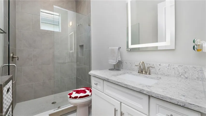 Bathroom with vanity and a tile shower