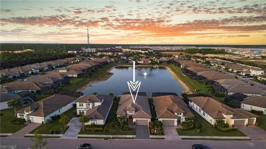 Aerial perspective of suburban area with a nearby body of water