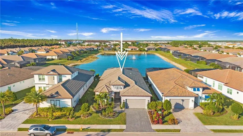 Aerial view of residential area featuring a large body of water