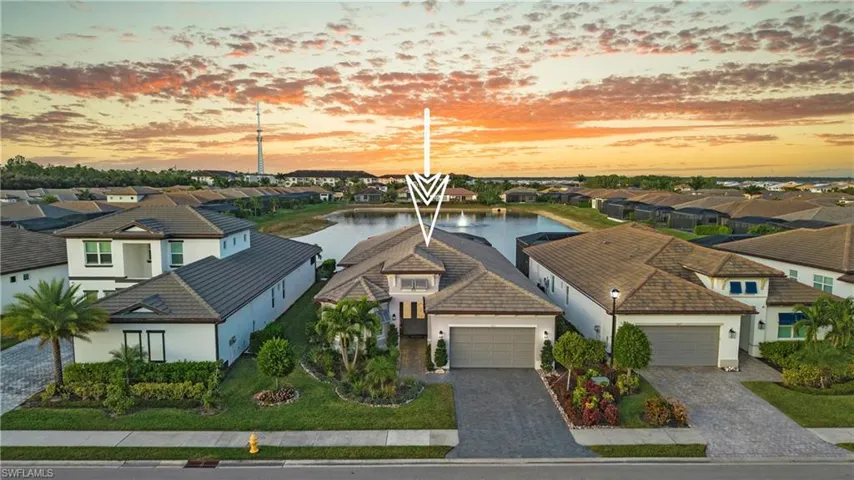 Aerial view at dusk of a water view and a residential view