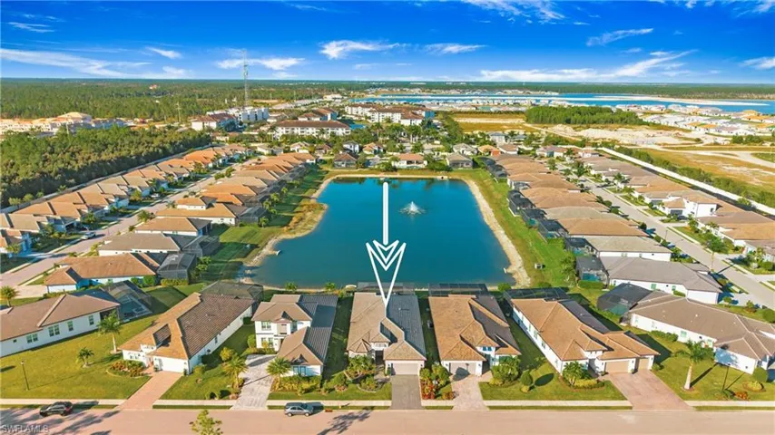 View of property location featuring a nearby body of water and nearby suburban area