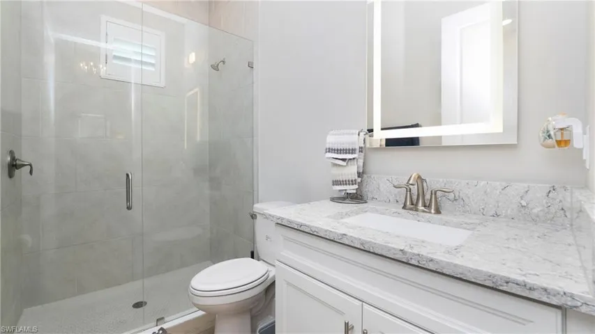 Full bath with vanity and a stall shower