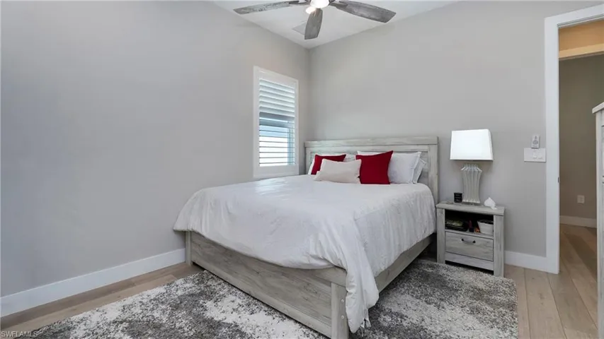 Bedroom with light wood-style floors and ceiling fan