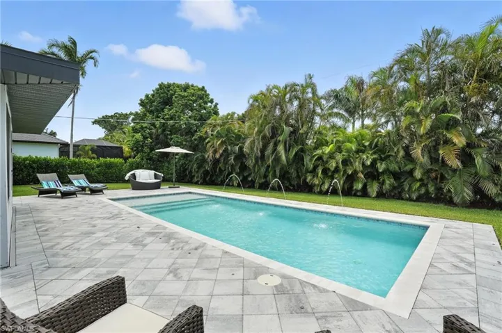 Sun-shelf, water feature and pavestone patio around pool