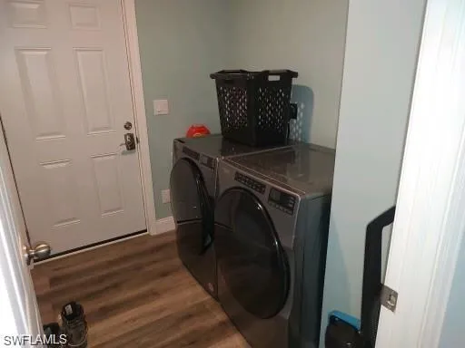 Laundry room with dark hardwood / wood-style floors and independent washer and dryer