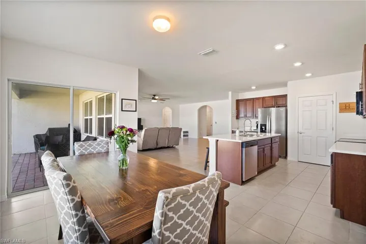 Dining space with sink, ceiling fan, and light tile patterned flooring