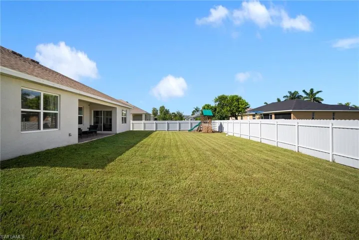 View of yard featuring a playground and a patio