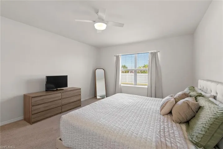 Bedroom featuring ceiling fan and light colored carpet
