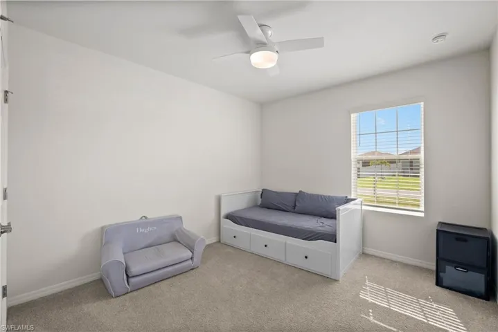 Sitting room with light carpet and ceiling fan