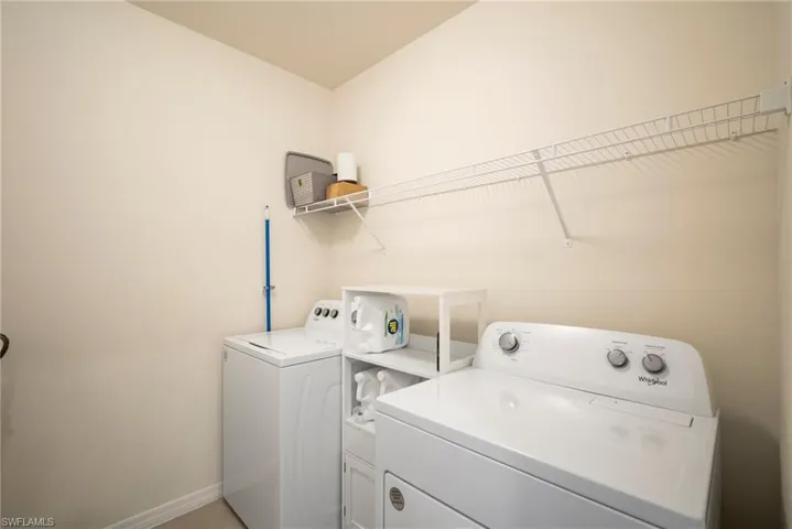 Washroom with washer and clothes dryer