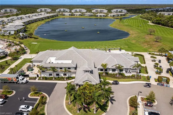Aerial perspective of suburban area with a large body of water and a local golf course